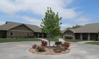 Courtyard with flower beds and trees.