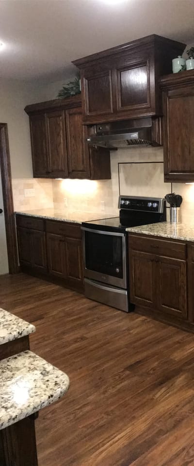 Modern kitchen design with wooden cabinets and granite countertops.