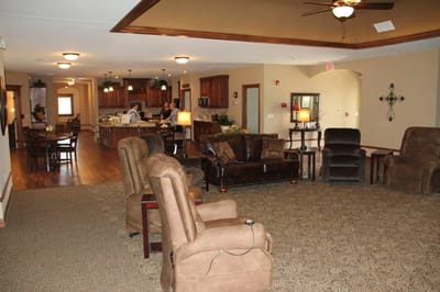 Common area with comfortable seating and kitchen view