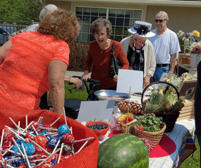 Residents engaging in outdoor gathering with food