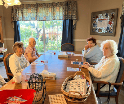 Seniors enjoying a game of bingo in a common area.