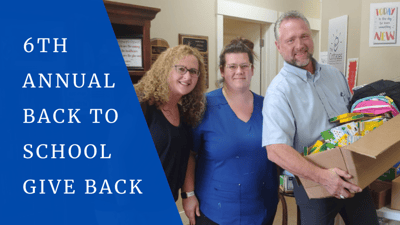 Staff and residents participating in a school supplies donation event.