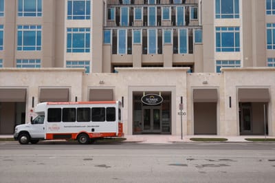 Front entrance of Sunrise of Coral Gables with transportation van