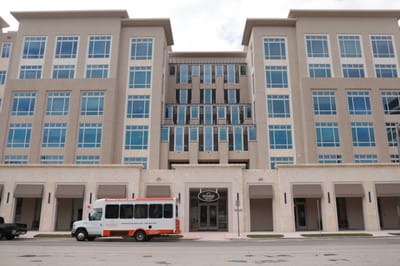 Exterior view of the Sunrise of Coral Gables facility with shuttle bus