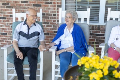 Two seniors enjoying time together on a porch