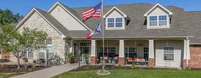 Beautiful exterior of Bickford of Marshalltown with American flags