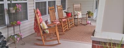 Outdoor seating area with rocking chairs and plants