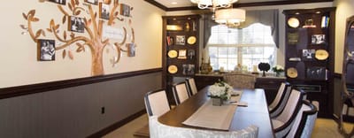 Common area with a decorative tree and dining table