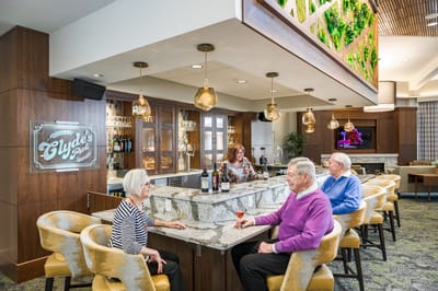 Residents enjoying drinks at a social bar area