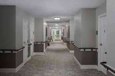 A hallway in the assisted living facility with doors and windows