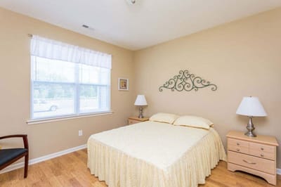 Cozy resident room with a queen bed and window