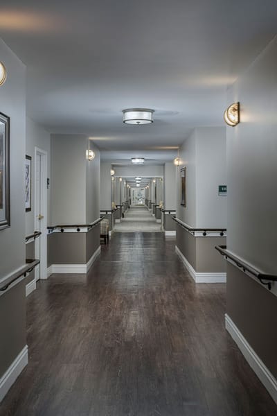 A well-lit corridor in a senior living facility