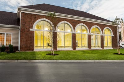 Exterior view of a senior living facility with large windows