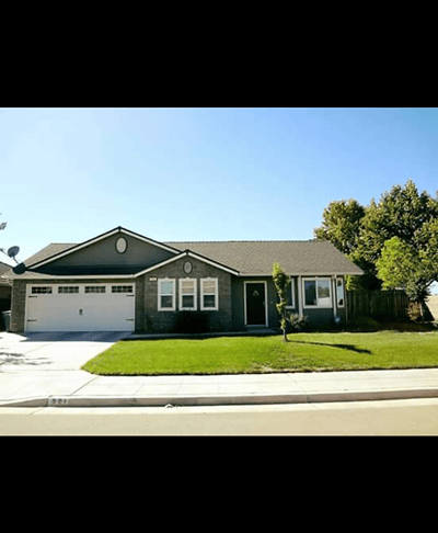 Exterior view of a single-story house with green lawn