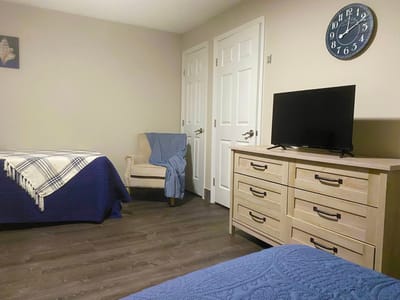 Private resident room with two beds and a television