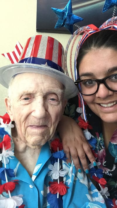 Senior resident and staff member celebrate together