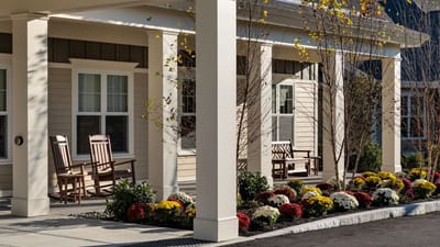 Outdoor seating area with flowers and rocking chairs