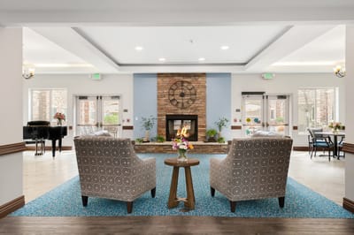 Bright common area with seating and fireplace