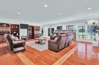 Bright common area with comfortable seating and windows