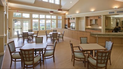 Bright and spacious common area with tables and chairs