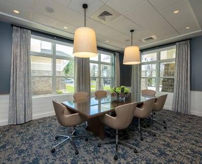 Bright common area conference room with large windows
