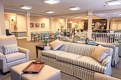 Common area with comfortable seating in a senior living facility
