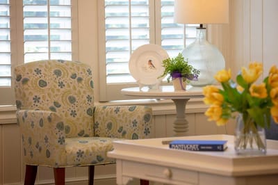 Cozy interior seating area with floral chair and table