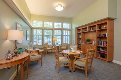 Bright interior common area with seating and bookshelves