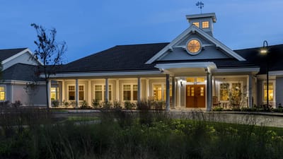 Exterior view of a senior living facility at dusk