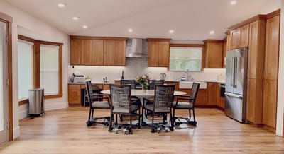 Bright kitchen area with wooden cabinets and seating