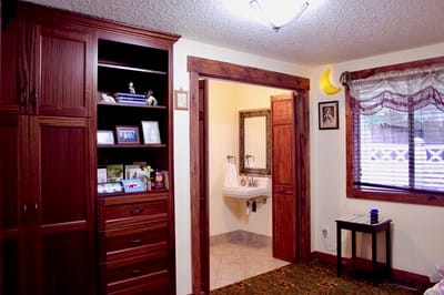 Bright interior of a resident's room with wooden furniture