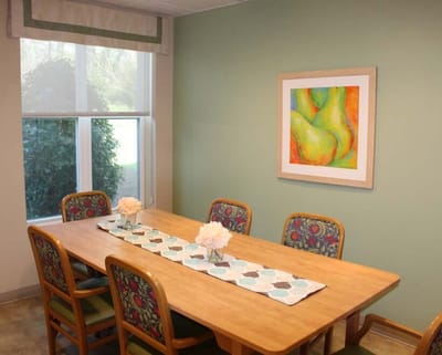 Bright dining area with a wooden table and floral decor