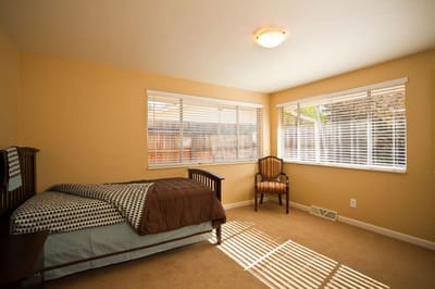 Private resident room with a bed and chair