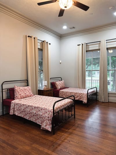 Cozy bedroom with two beds and natural light