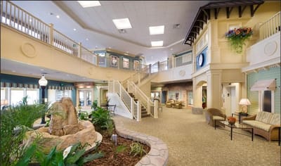 Bright, spacious lobby area with seating and plants