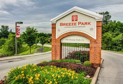 Entrance sign of Breeze Park with landscaped flowers