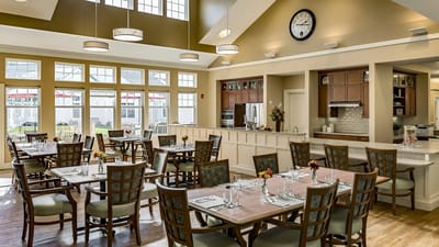 Dining area set for a meal service with natural light