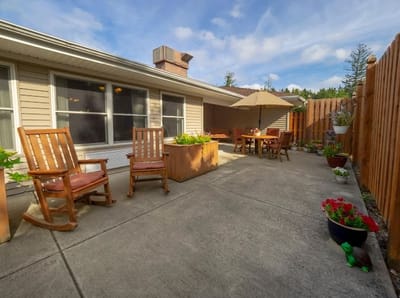 Outdoor patio area with rocking chairs and plants