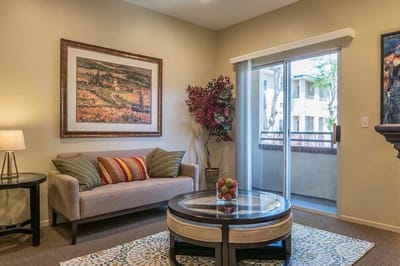 Bright living room with a cozy sofa and balcony access