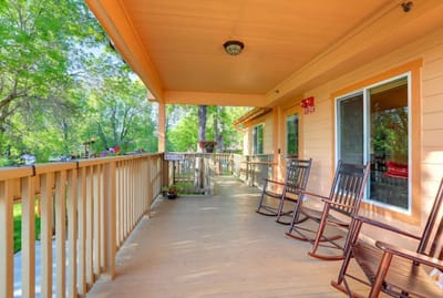 Outdoor porch with rocking chairs and natural surroundings