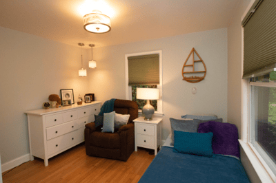 Comfortable bedroom setup with a chair and dresser