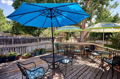 Outdoor seating area with umbrellas and flower pots
