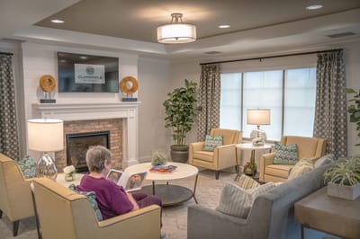 Resident reading in a cozy common area