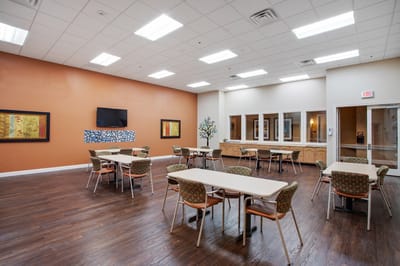 Spacious common area with tables and chairs