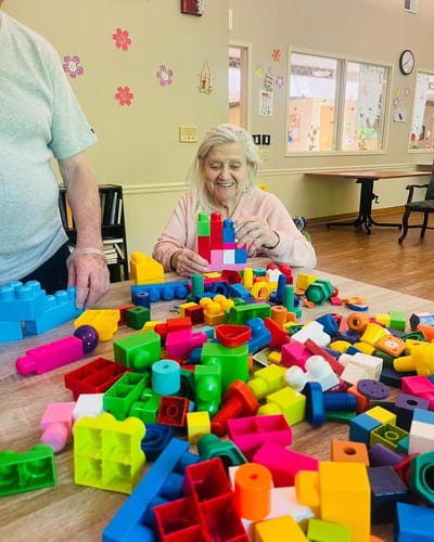 Resident engaged in building activity with colorful blocks