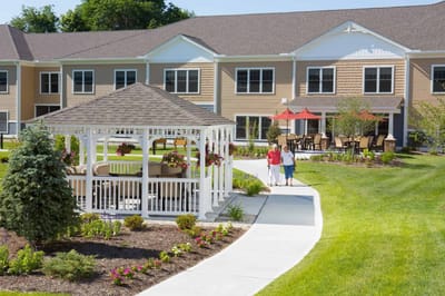 Two residents walking in a landscaped garden area