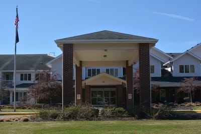 Front entrance of a senior living facility with landscaping