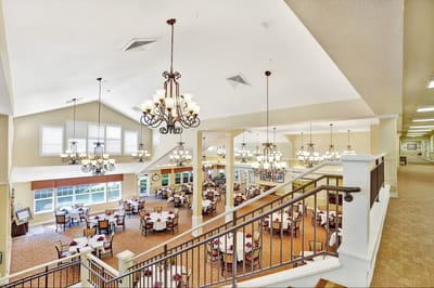 Interior view of a dining area with tables and chandeliers