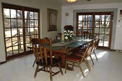 A dining room with a table and chairs