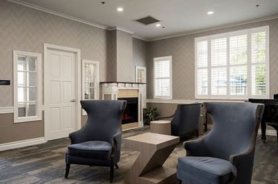 Cozy common area with blue chairs and modern decor